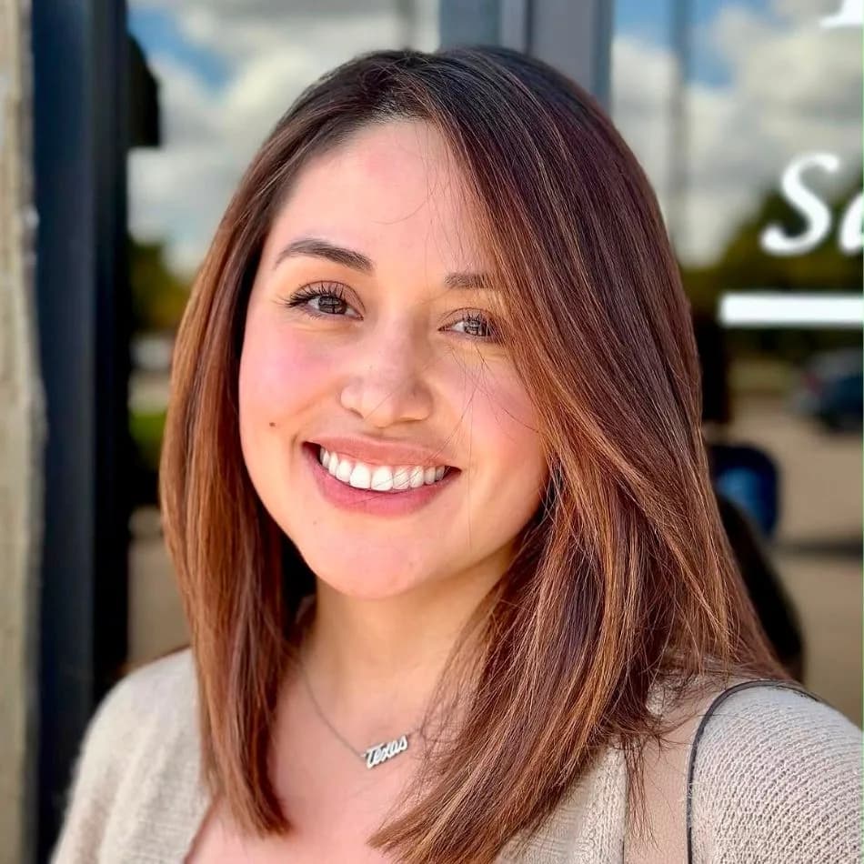 Client smiling with shoulder-length auburn brown hair color after salon visit at Salon Lola in Gilbert, Arizona